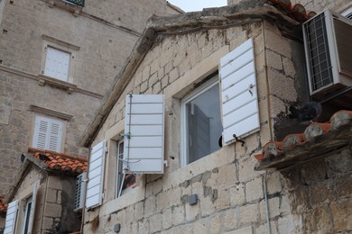 Beautiful old city buildings with windows, low angle view