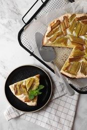 Photo of Freshly baked rhubarb pie and cake server on white marble table, flat lay