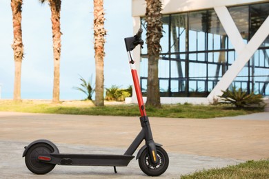 Photo of Modern electric scooter on city street. Rental service