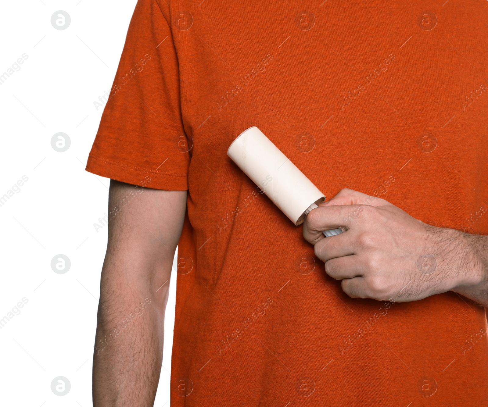 Photo of Man using lint roller on white background, closeup