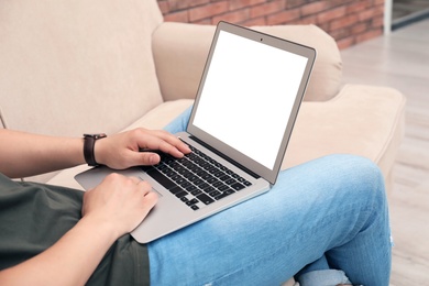 Photo of Man in casual clothes with laptop indoors
