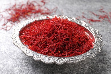 Dried saffron on grey table, closeup view