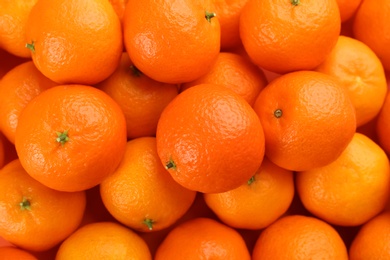 Photo of Fresh ripe tangerines as background, top view