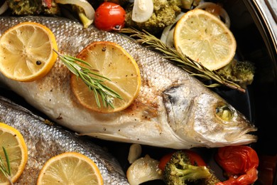 Baked fish with vegetables, rosemary and lemon, flat lay