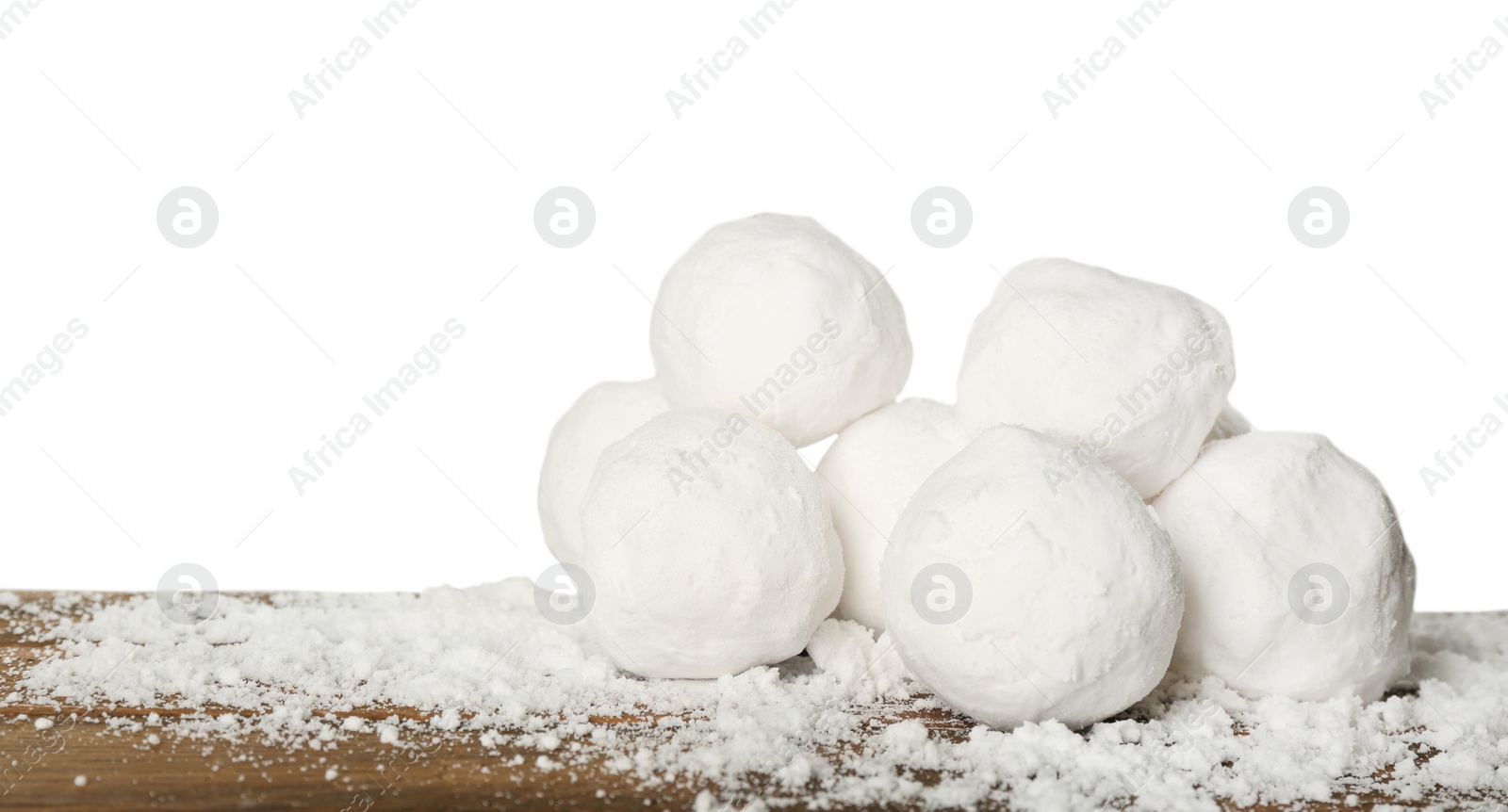 Photo of Snowballs on wooden table against white background