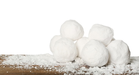 Photo of Snowballs on wooden table against white background