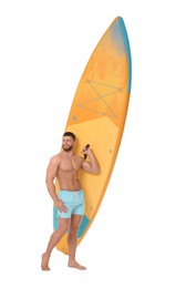 Photo of Happy man with orange SUP board on white background