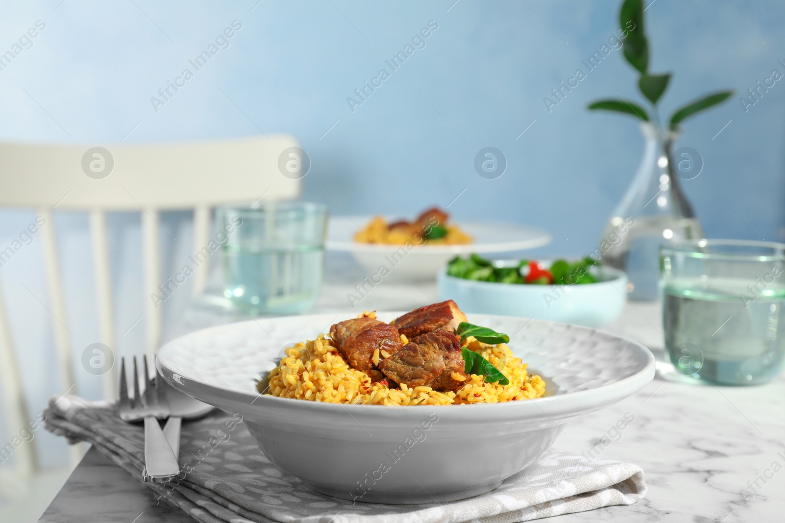 Photo of Plate with delicious rice pilaf served on table