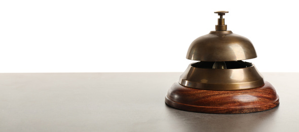 Hotel service bell on grey stone table against white background