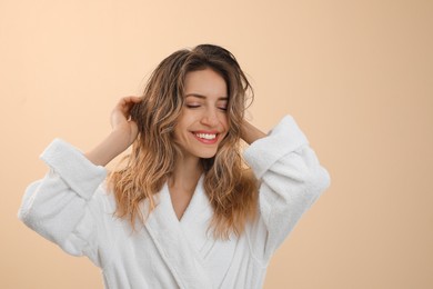 Photo of Young woman with beautiful washed hair on light yellow background