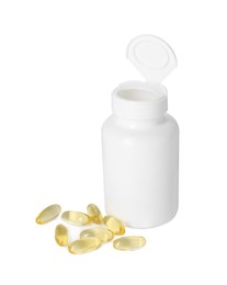 Photo of Bottle and pile of softgel capsules isolated on white