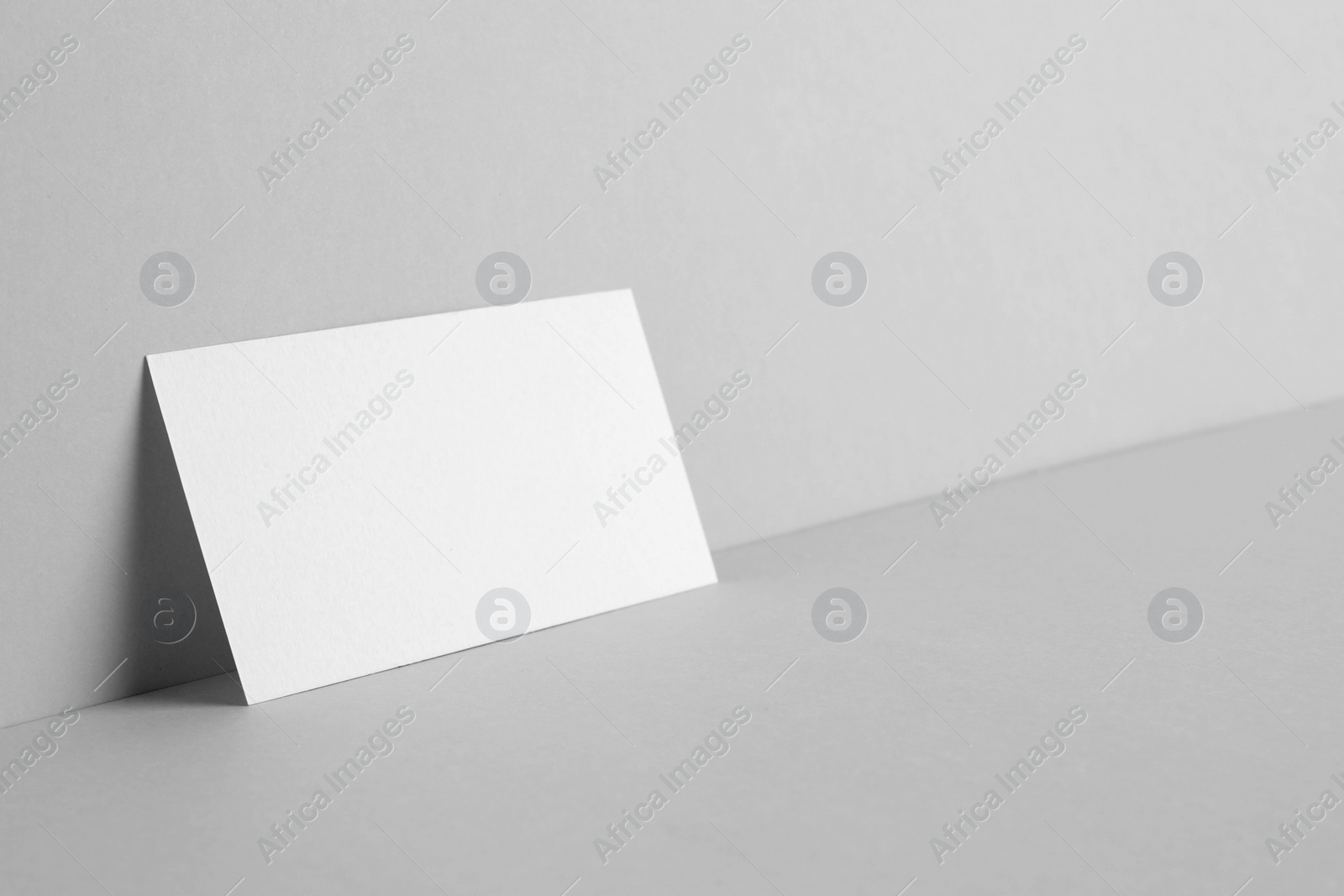 Photo of Blank business card on light grey background. Mockup for design