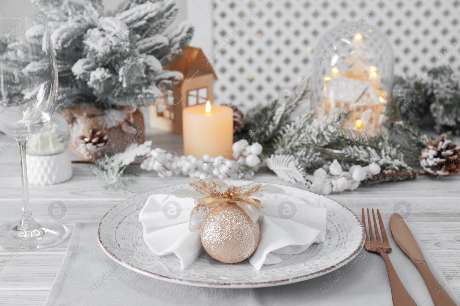 Photo of Festive place setting with beautiful dishware, cutlery and decor for Christmas dinner on white wooden table