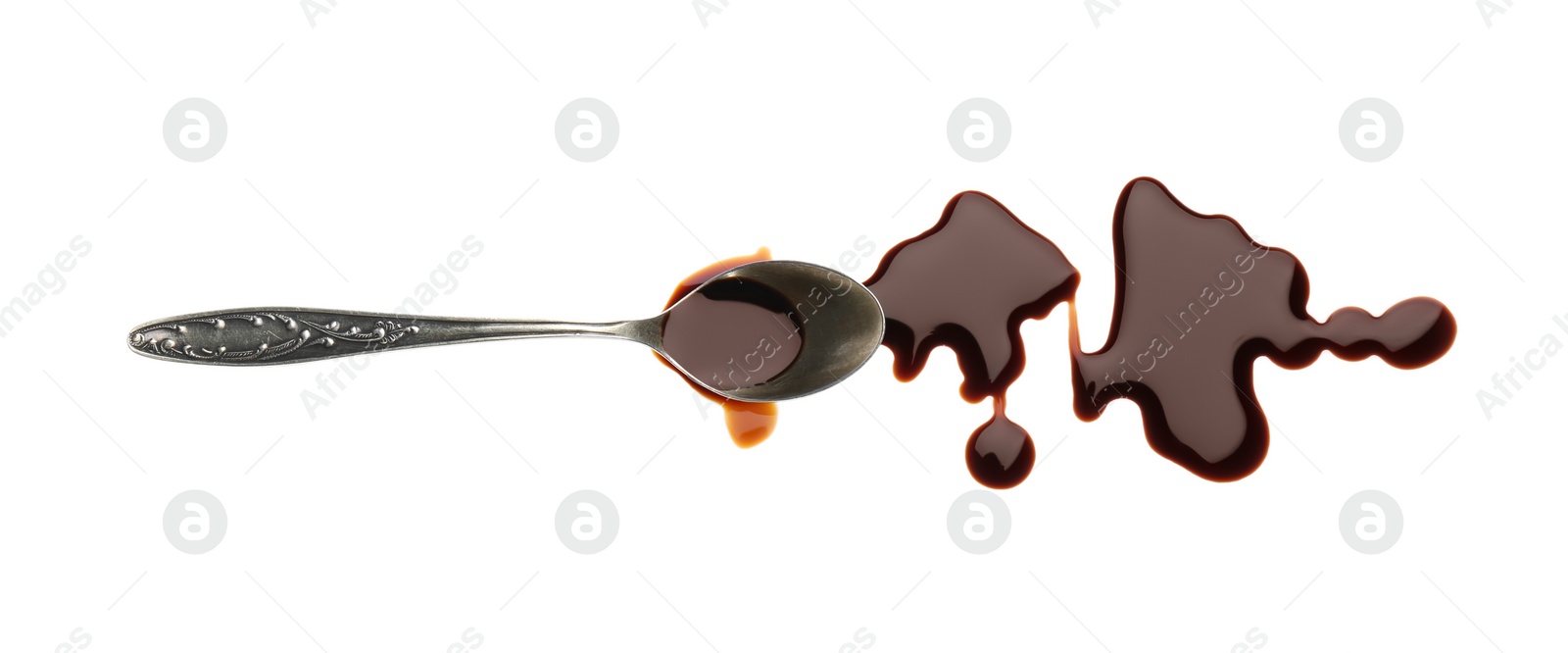 Photo of Spilled soy sauce and spoon on white background, top view