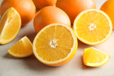 Fresh juicy oranges on light table, closeup