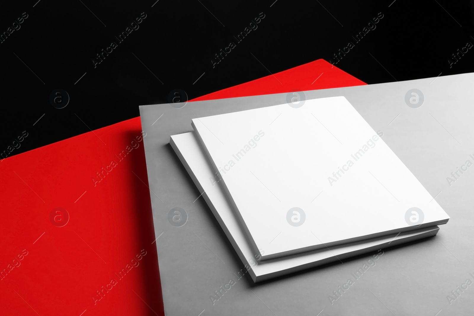 Photo of Empty stacks of papers on color background. Mockup for design