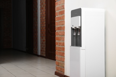 Photo of Modern water cooler in office hall