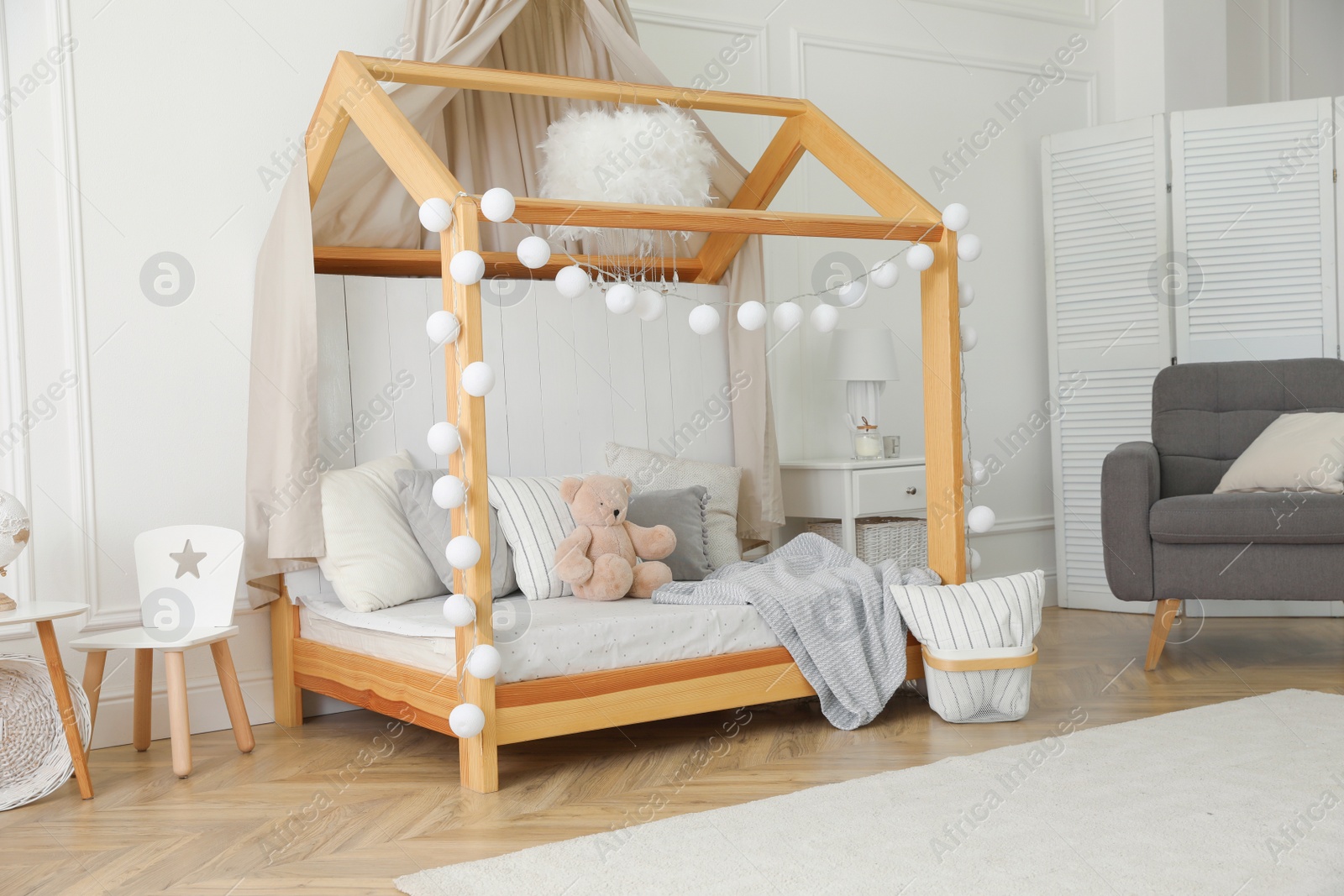 Photo of Stylish room for kid with house bed. Interior design