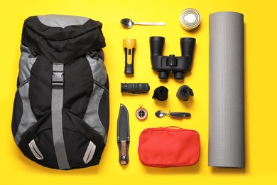 Photo of Flat lay composition with different camping equipment on color background