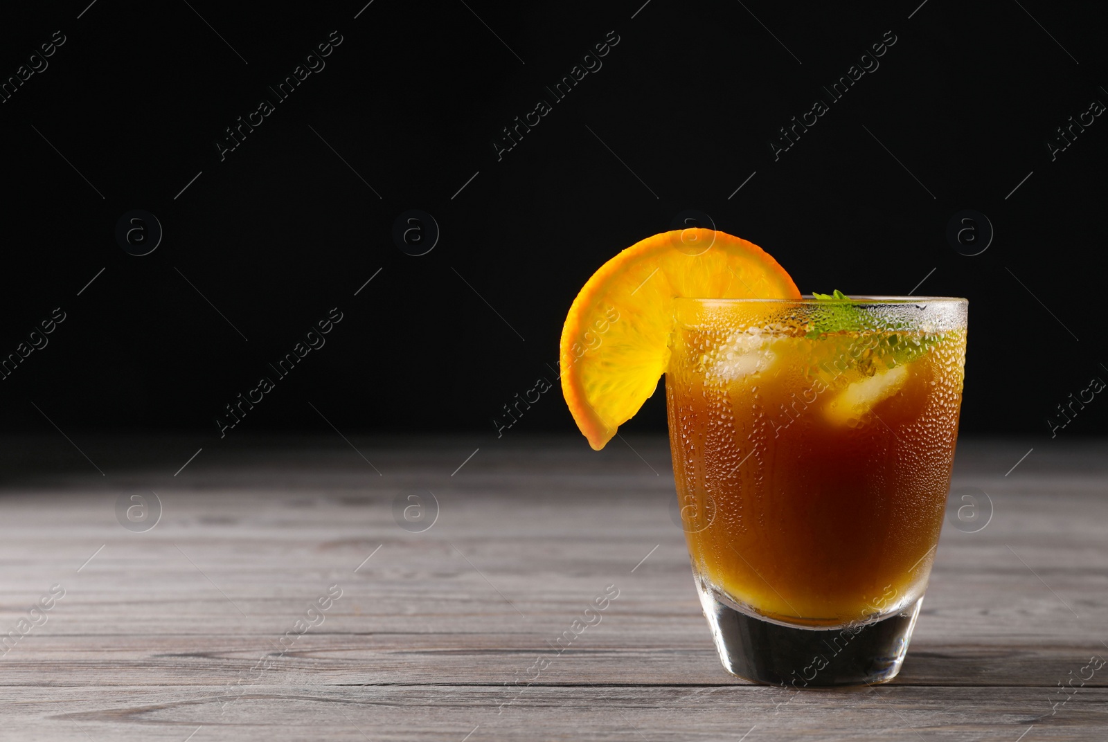 Photo of Tasty refreshing drink with coffee and orange juice on wooden table, space for text