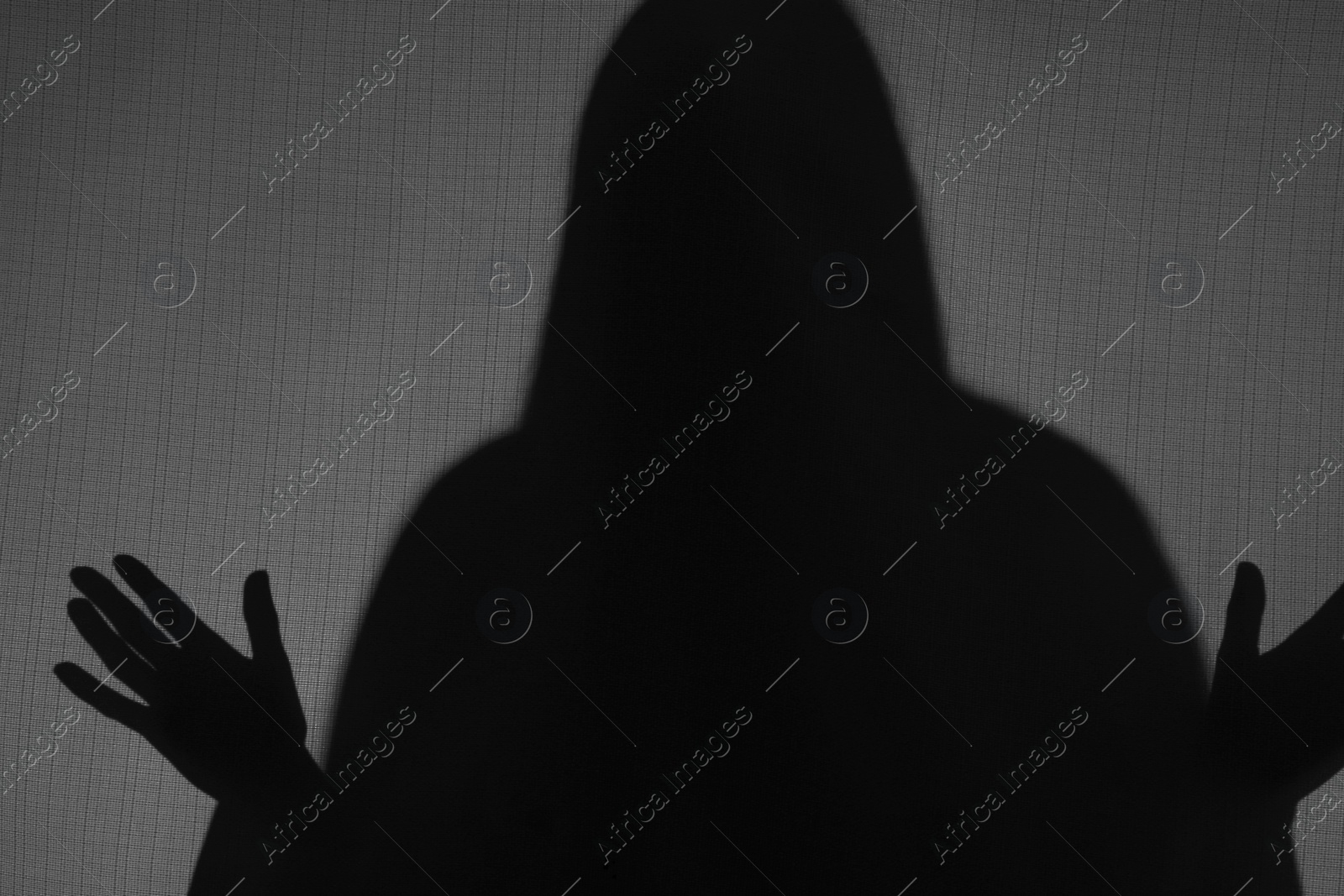 Photo of Silhouette of creepy ghost behind grey cloth