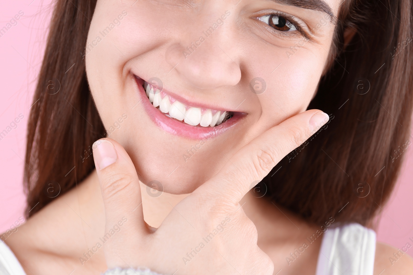 Photo of Young woman with beautiful smile on color background, closeup