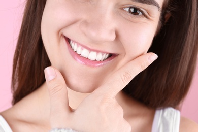 Young woman with beautiful smile on color background, closeup