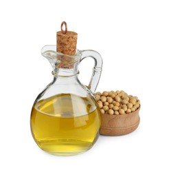 Photo of Glass jug of oil and soybeans on white background