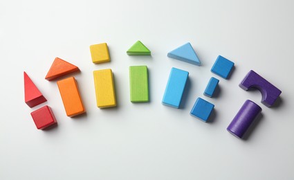 Photo of Colorful wooden construction set on white background top view