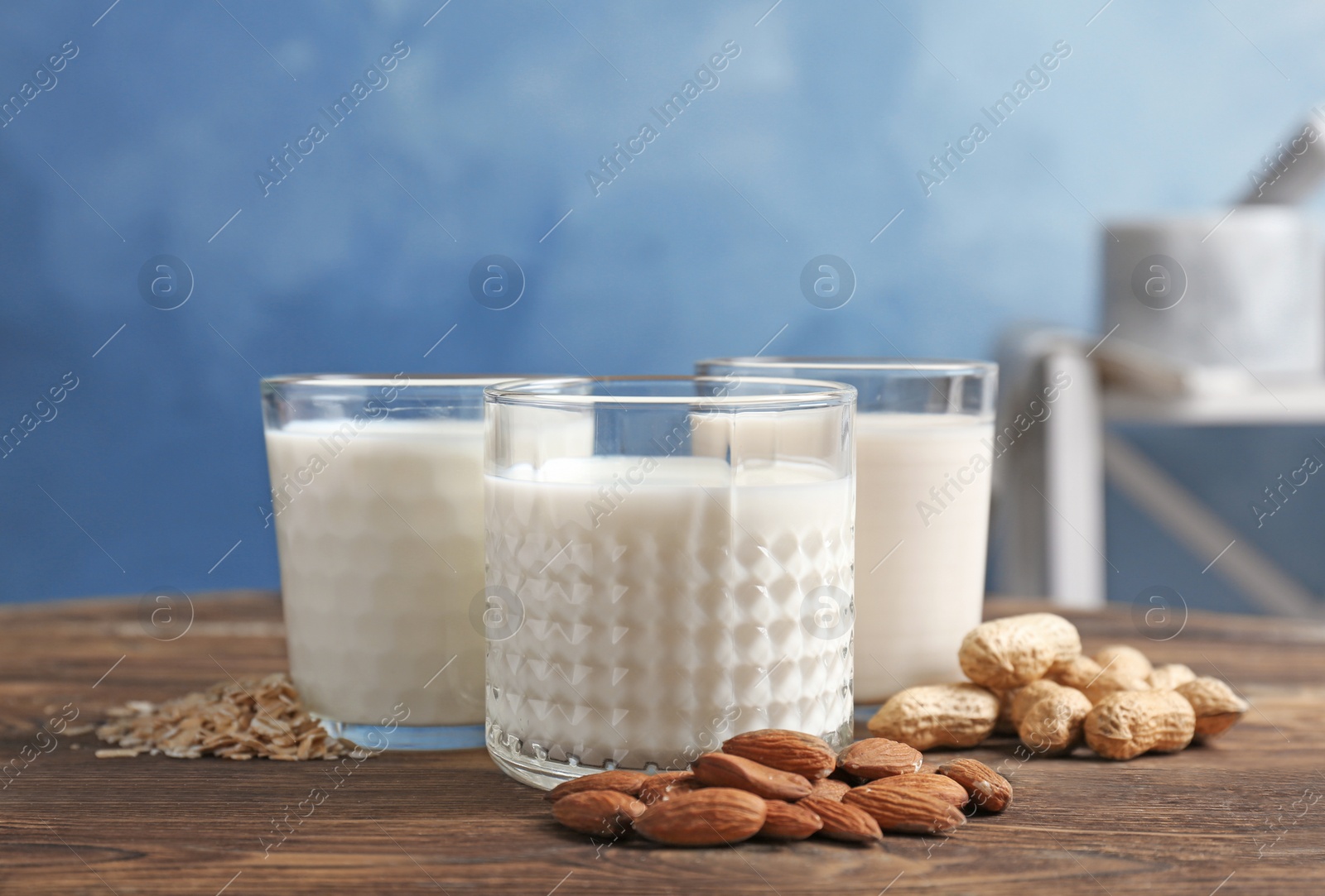 Photo of Glasses with different types of milk on wooden table