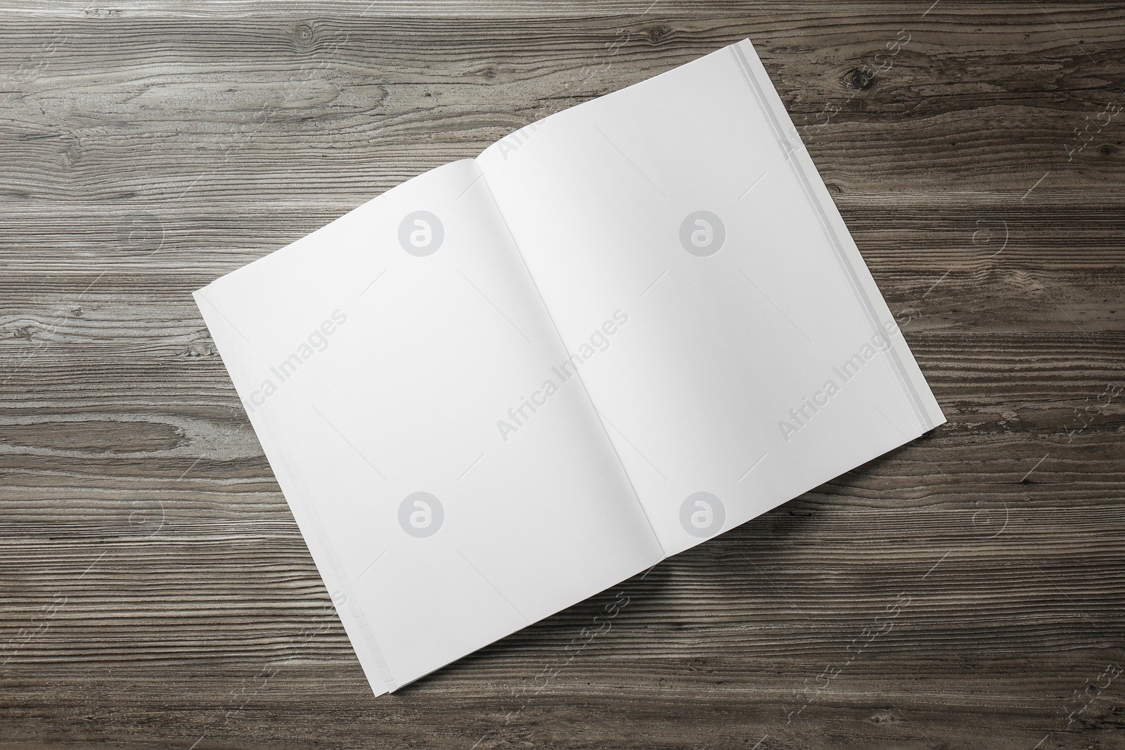 Photo of Open blank paper brochure on wooden table, top view. Mockup for design