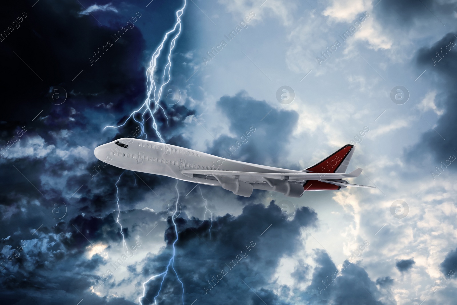 Image of Airplane flying in cloudy sky during thunderstorm