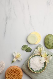 Photo of Flat lay composition with spa products and flowers on white marble table. Space for text