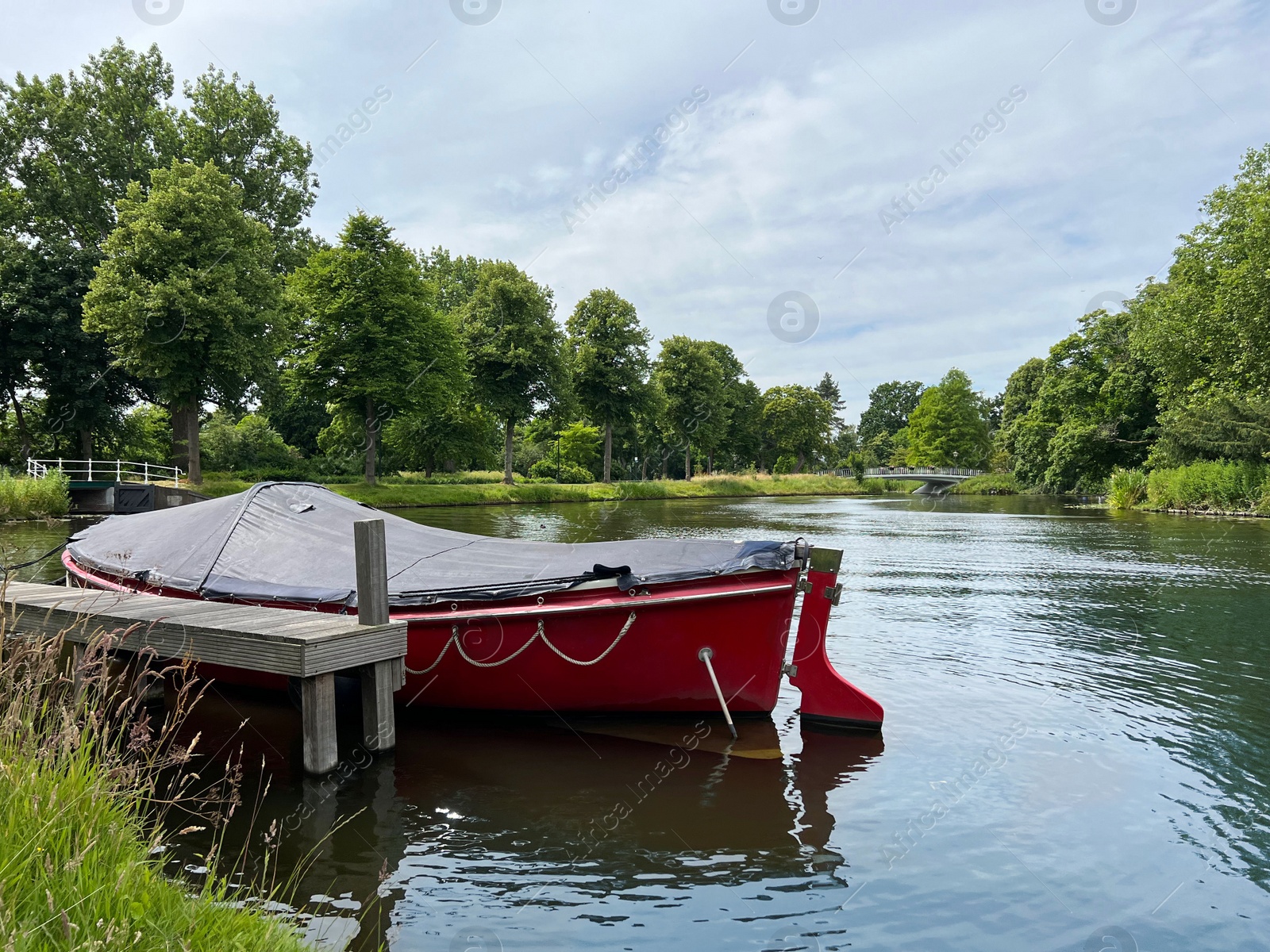 Photo of Beautiful view of canal with moored boat on sunny day