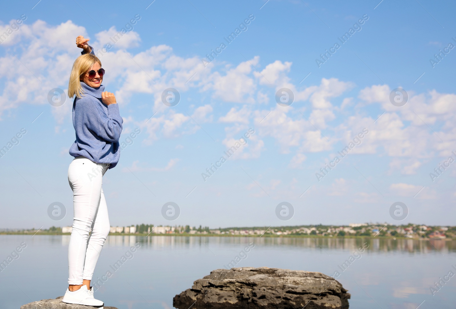 Photo of Happy woman in stylish sweater on beach