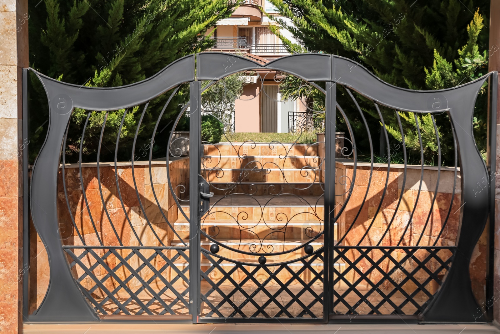 Photo of Beautiful black metal gates near house outdoors