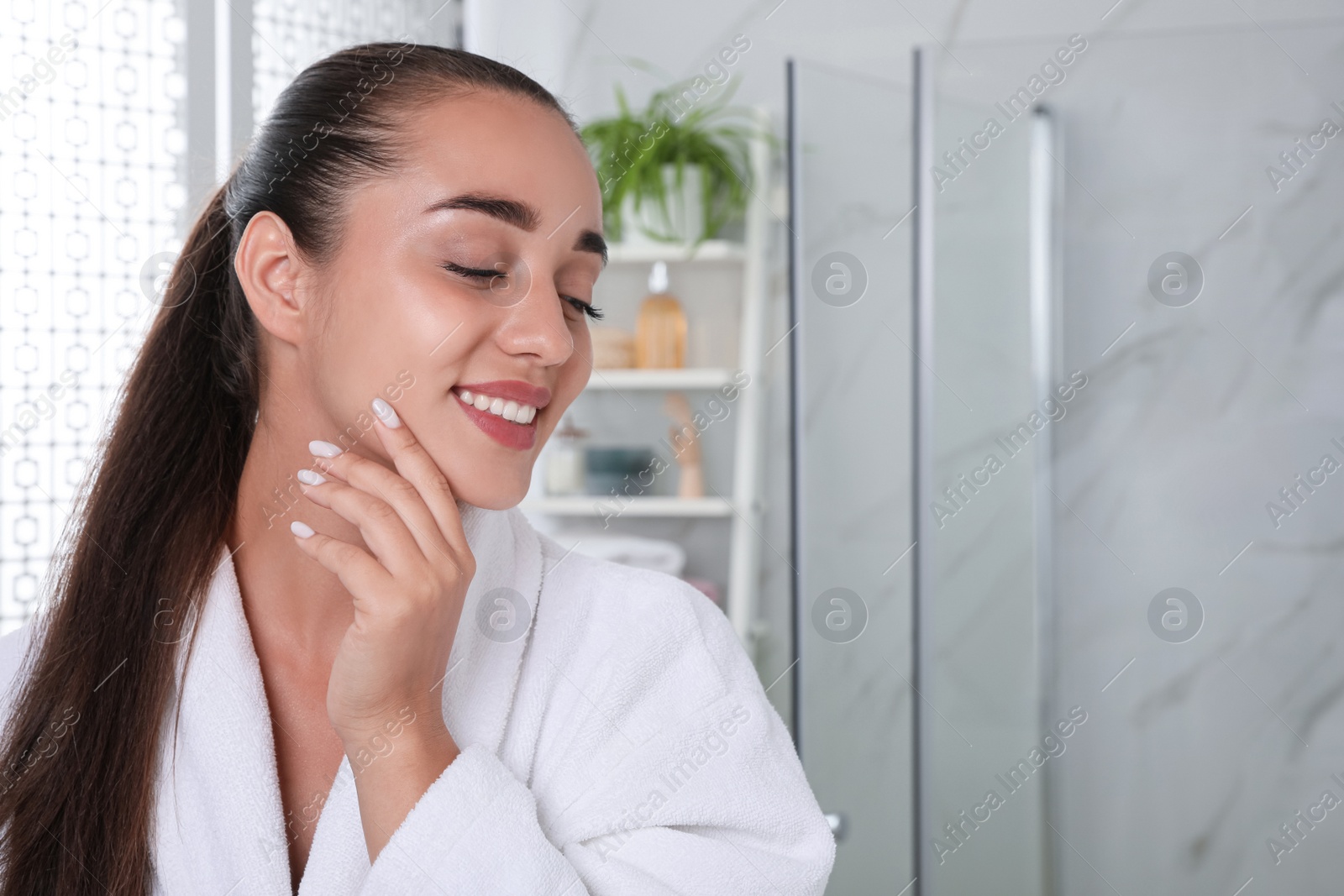 Photo of Beautiful young woman with perfect skin in bathroom, space for text. Facial wash