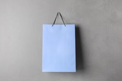 Photo of Paper shopping bag hanging on grey wall