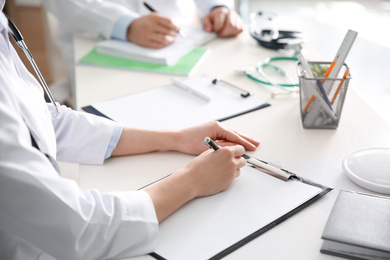 Photo of Doctors having meeting at table in office, closeup