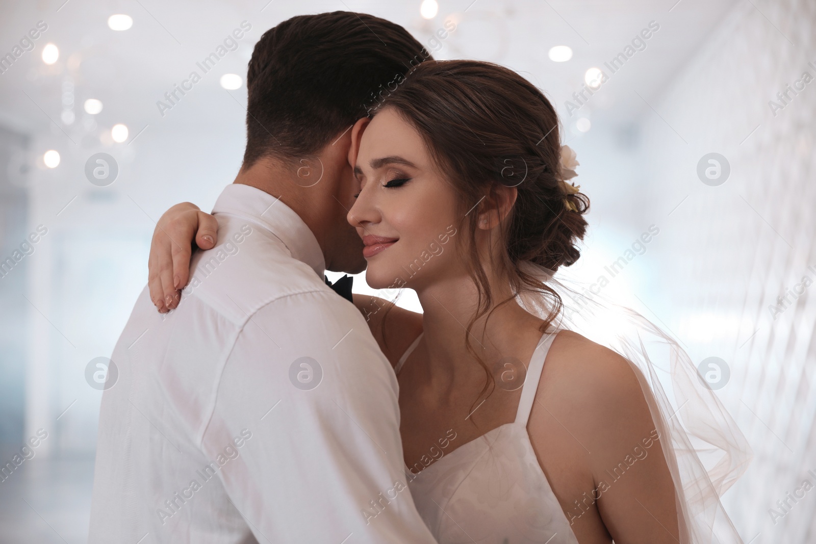 Photo of Happy newlywed couple dancing together in festive hall