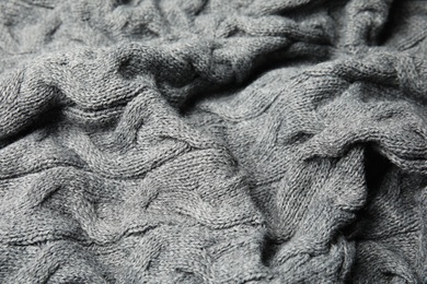 Photo of Soft grey knitted plaid as background, closeup