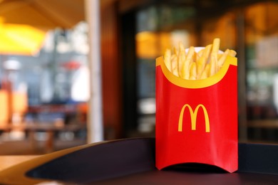 Photo of MYKOLAIV, UKRAINE - AUGUST 11, 2021: Big portion of McDonald's French fries on tray in cafe. Space for text