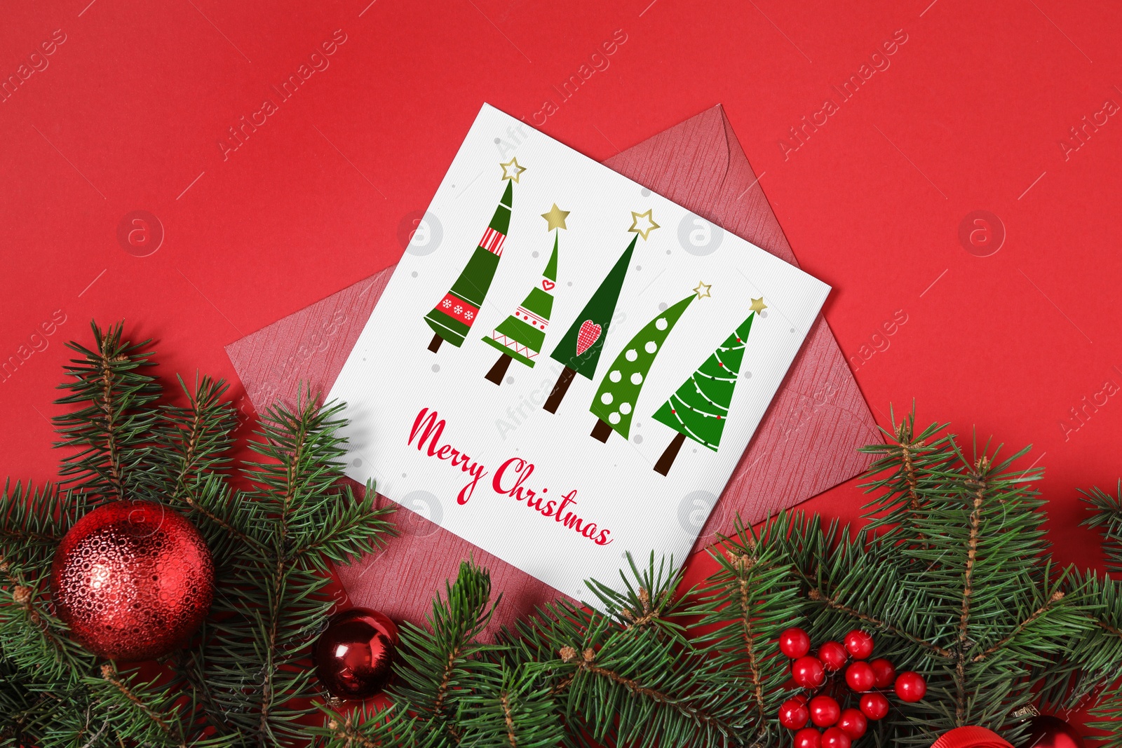 Image of Greeting card with text Merry Christmas on red background, flat lay