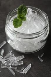 Menthol crystals and mint leaves on grey background