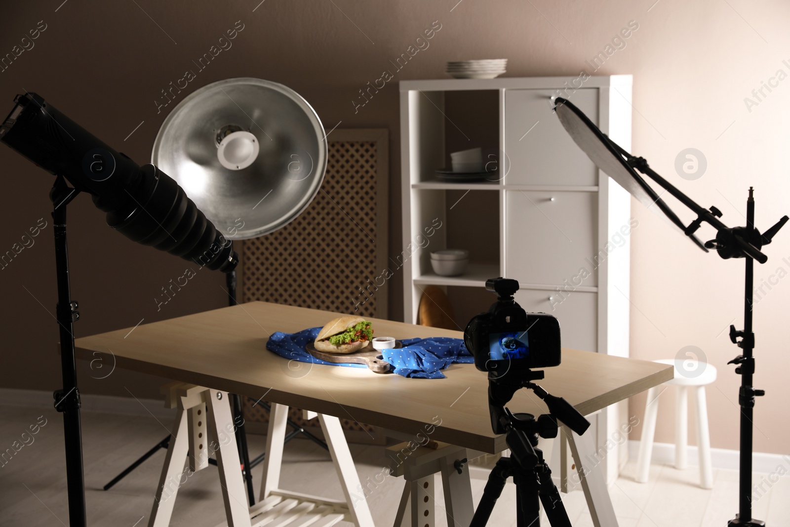 Photo of Professional camera on tripod and composition with tasty sandwich in photo studio. Food photography