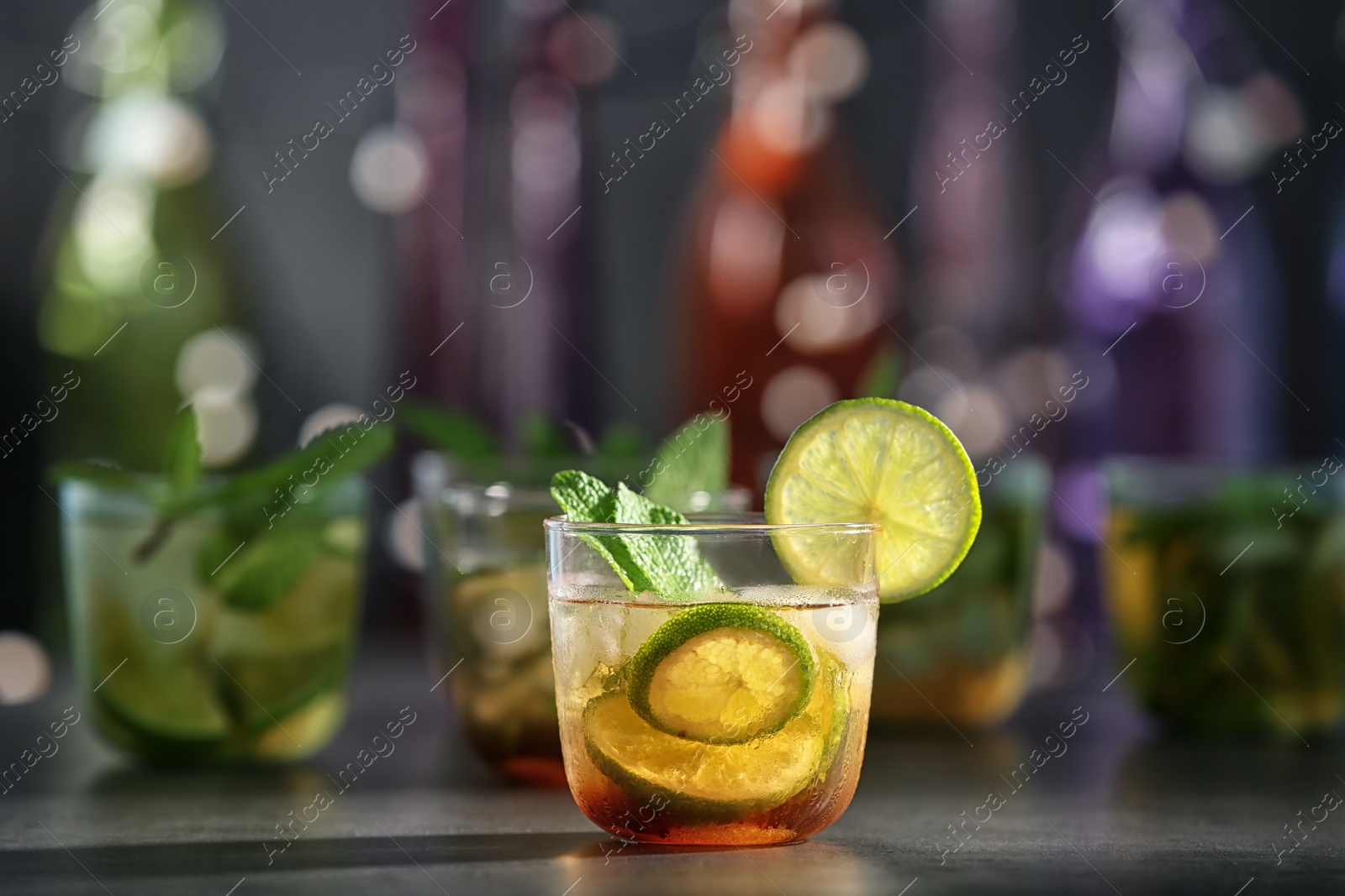 Photo of Glass with delicious mint julep cocktail on bar counter