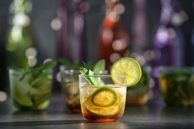 Photo of Glass with delicious mint julep cocktail on bar counter