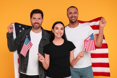 4th of July - Independence Day of USA. Happy friends with American flags on yellow background
