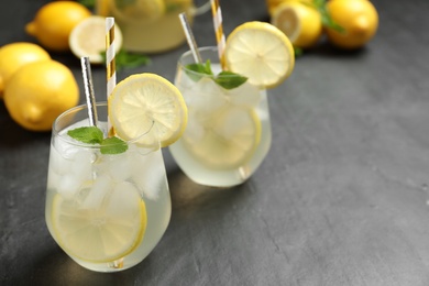 Natural lemonade with mint on grey table, space for text. Summer refreshing drink