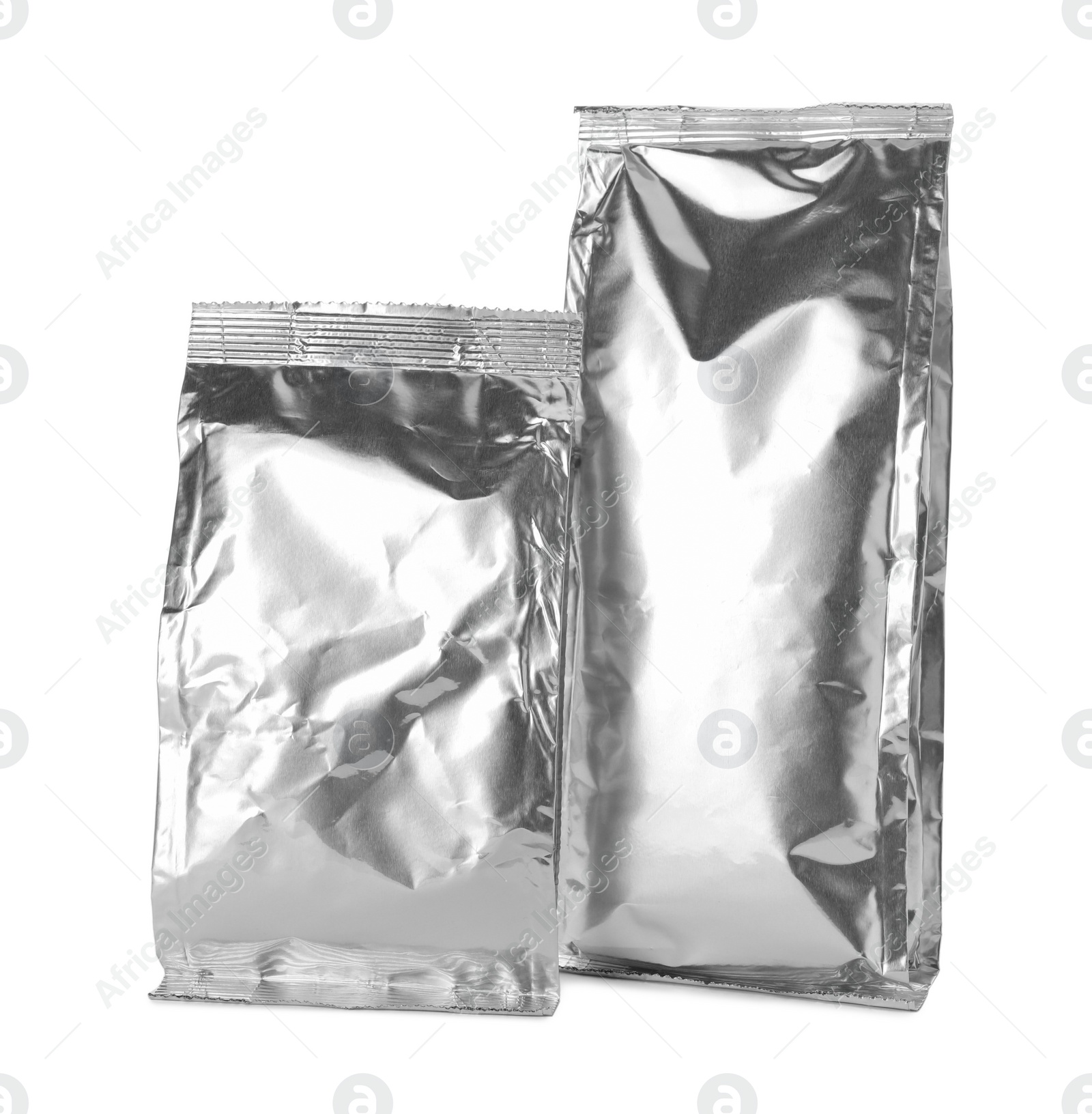 Photo of Blank foil packages for products on white background